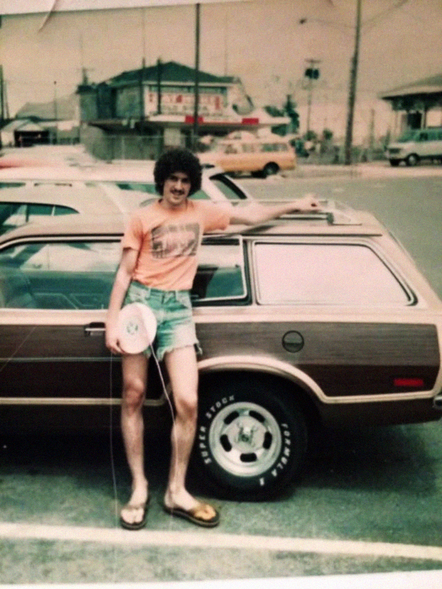 A man standing next to a car