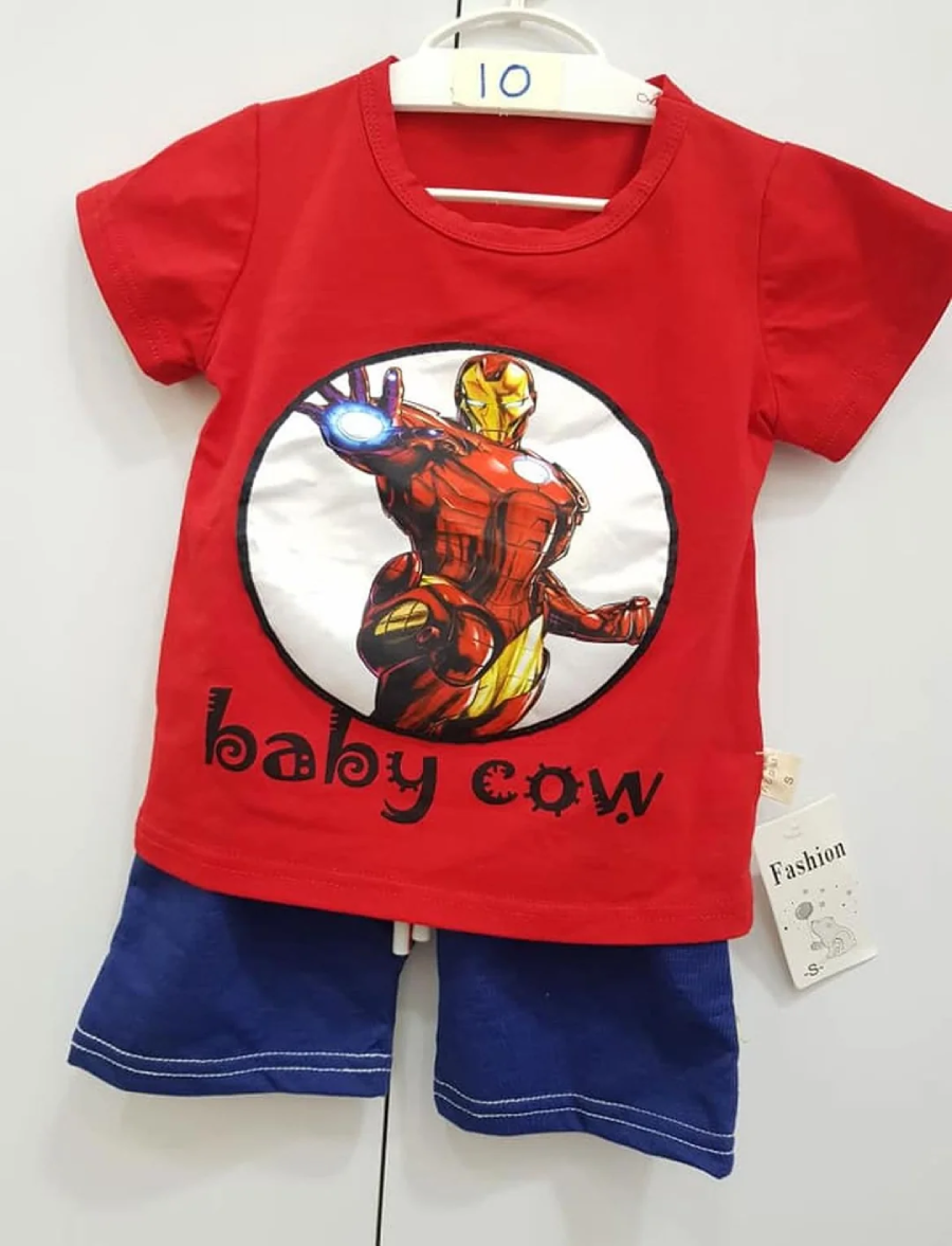 A red baby t-shirt with an Iron Man graphic and the text "baby cow," paired with blue shorts, hanging on a white hanger labeled "10." A fashion tag is attached to the shorts.