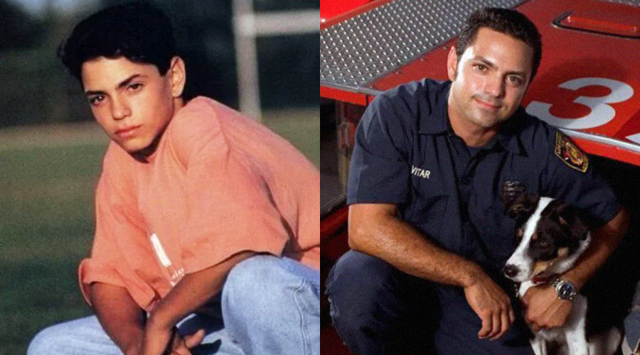 Side-by-side photos of a young man in a pink shirt and jeans outdoors on the left, and an adult man in a dark uniform kneeling beside a dog near a fire truck on the right.