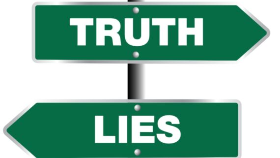 Two green road signs point in opposite directions; the top sign reads "TRUTH" and the bottom sign reads "LIES.