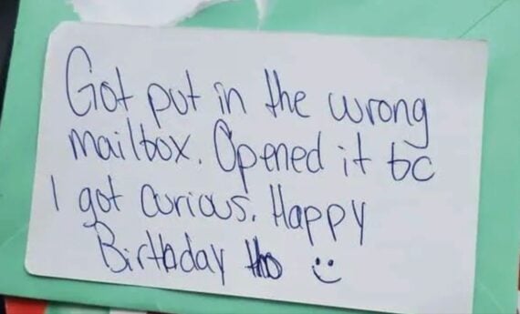 A handwritten note on white paper reads: &ldquo;Got put in the wrong mailbox. Opened it bc I got curious. Happy Birthday tho :)&rdquo; on a green background.