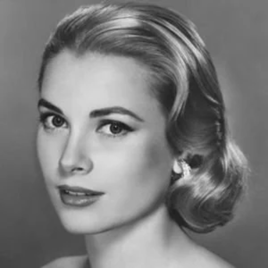 Black and white portrait of a woman with light hair styled in soft waves, wearing earrings and looking slightly to the side with a calm expression.