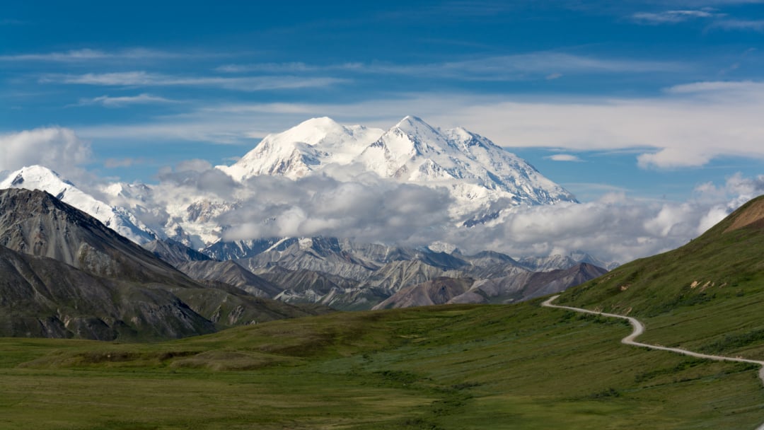 A mountain range with clouds in the sky