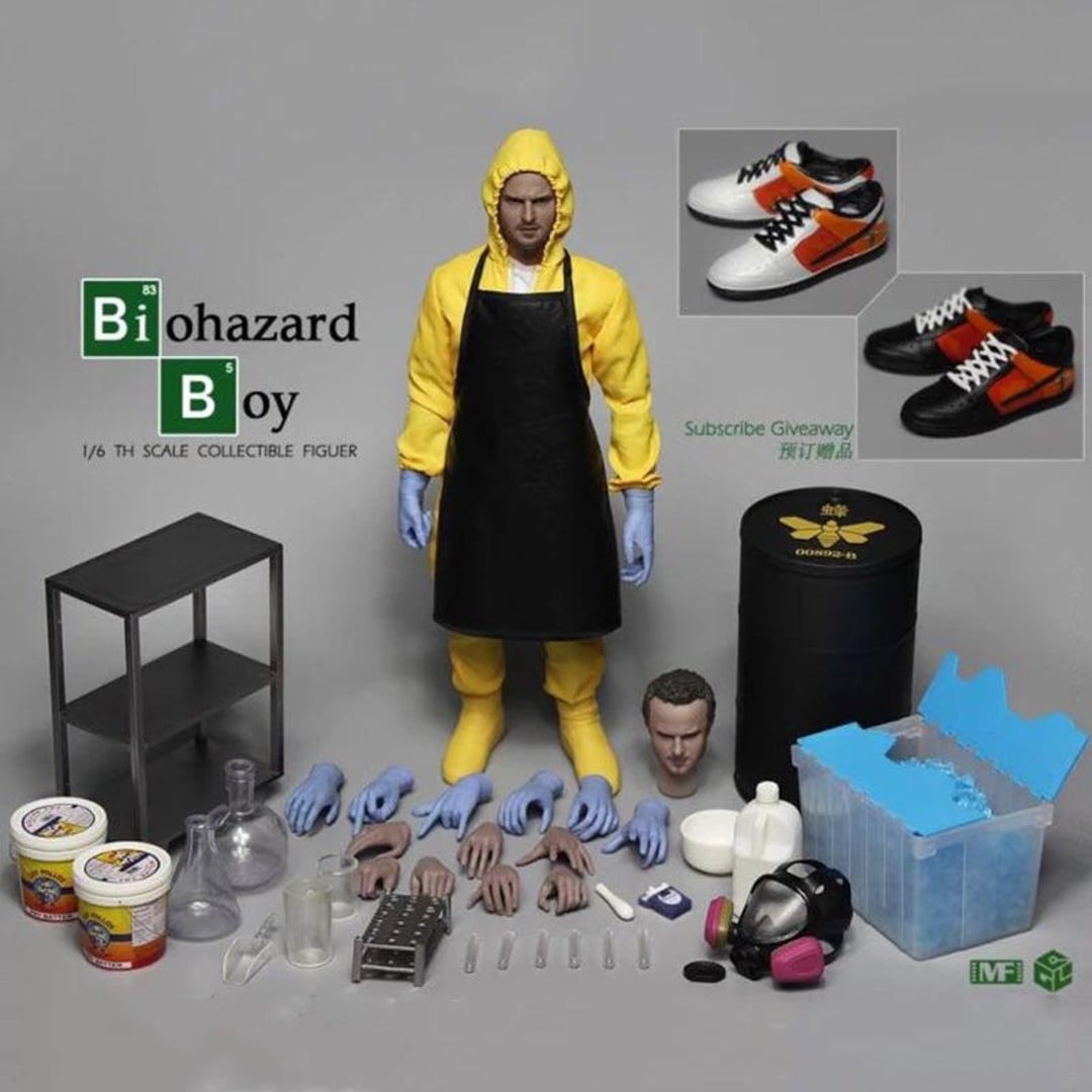 A collectible action figure wearing a yellow hazmat suit, black apron, and gloves is surrounded by accessories: extra hands, a head, containers, a gas mask, shoes, blue crystals, barrels, and lab equipment.