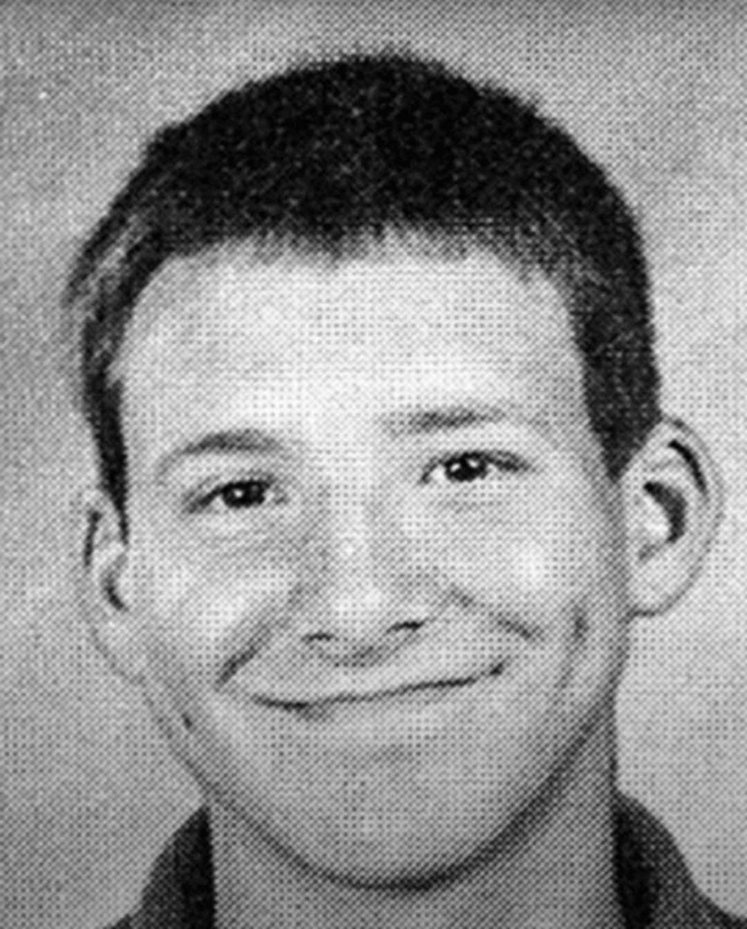 Black and white yearbook-style portrait of a young person with short hair, smiling slightly, against a plain background.