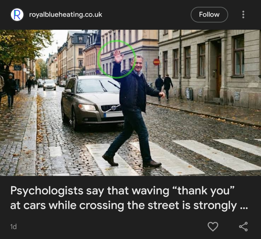 A man crossing a cobblestone street waves thank you to a car that stopped for him. The crosswalk is wet from rain, and the street is lined with parked cars and buildings.