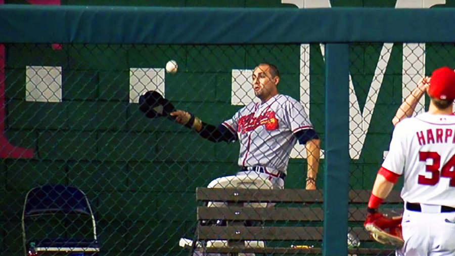 A man in a baseball uniform throwing a baseball