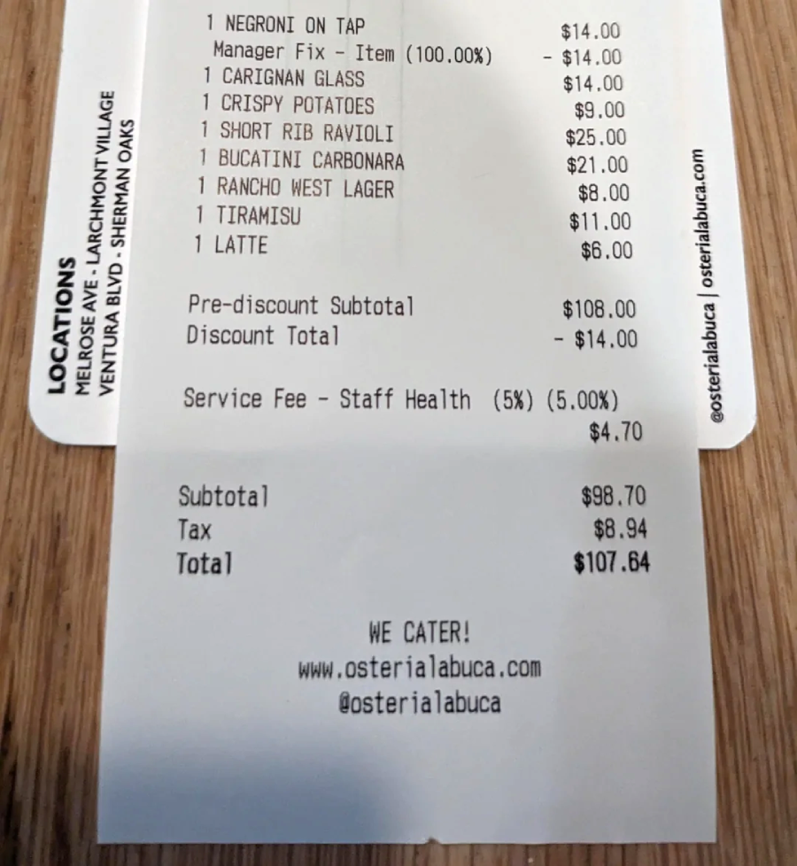A restaurant receipt listing various food and drink items, their prices, subtotal, service fee, discount, tax, and total amount due of $107.64. The receipt includes contact info and mentions catering services.