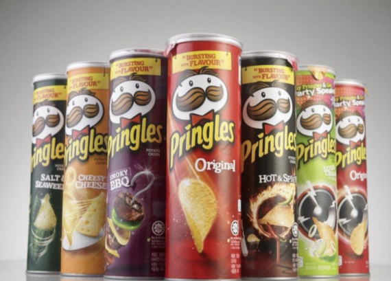A row of Pringles cans in various flavors, including Original, Hot & Spicy, Cheesy Cheese, Smoky BBQ, Salt & Seaweed, Sour Cream & Onion, and others, displayed on a light background.