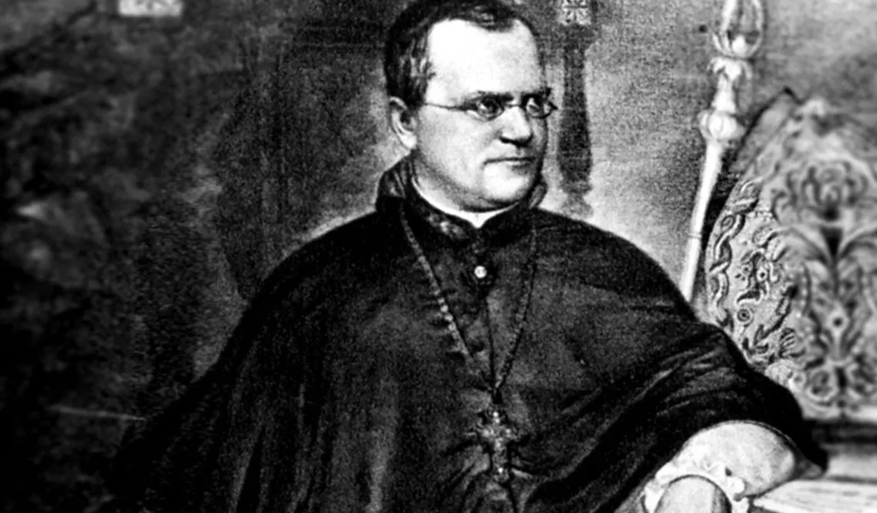 A black-and-white portrait of a man wearing glasses and clerical robes, seated with one arm resting to the side, looking slightly to his right. The style suggests a historical figure, possibly from the 19th century.