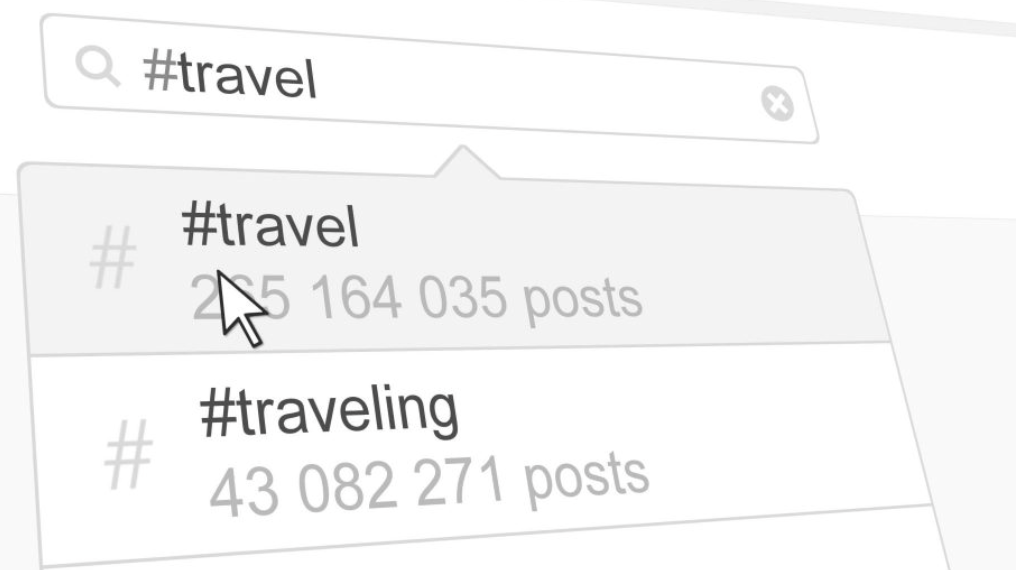 A computer cursor hovers over the hashtag “#travel” in a search bar, showing it has 255,164,035 posts. Below, “#traveling” appears with 43,082,271 posts. The image is in grayscale.