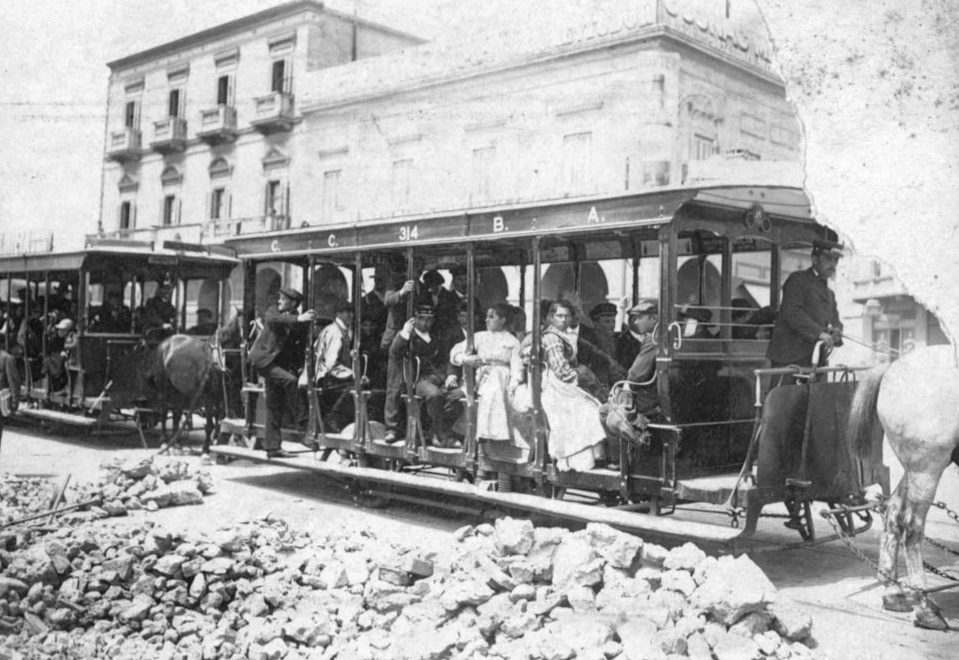 A black and white photo of people on a trolley
