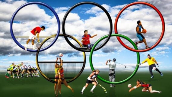 Athletes play various sports, including volleyball, basketball, rugby, tennis, golf, hockey, and soccer, with large Olympic rings and a cloudy sky in the background.