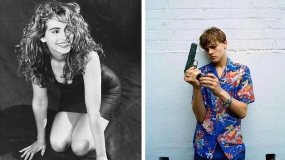 On the left, a woman with curly hair in a black dress kneels and smiles. On the right, a young man in a floral shirt stands against a white wall, looking at and holding a handgun.