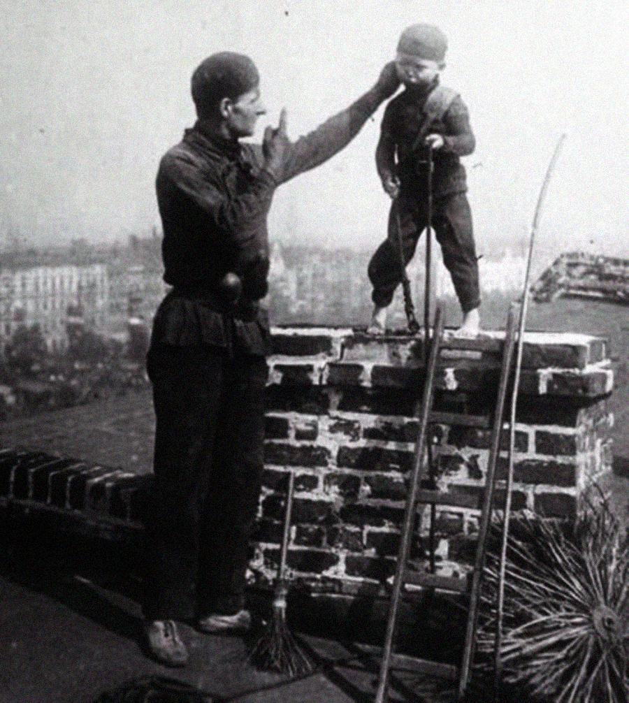 A man helps a small child, both in chimney sweep clothes, stand on a rooftop beside a brick chimney. Brushes and rods are nearby, and a cityscape is visible in the background.