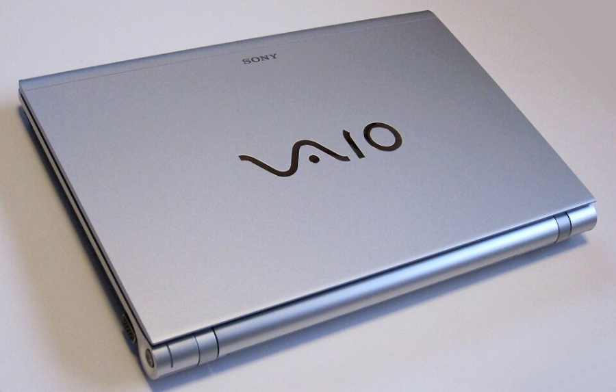A closed silver Sony VAIO laptop placed on a light surface, showing the VAIO logo on the top cover.