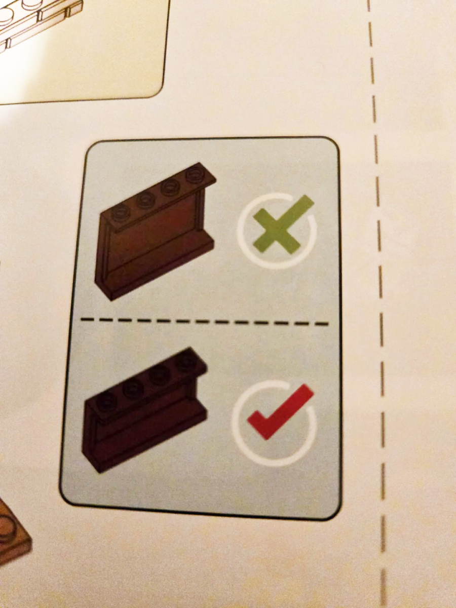 Lego instruction page showing a sloped brown brick with studs on the top incorrectly used (with a green X), and the correct usage with studs facing forward (with a red checkmark).