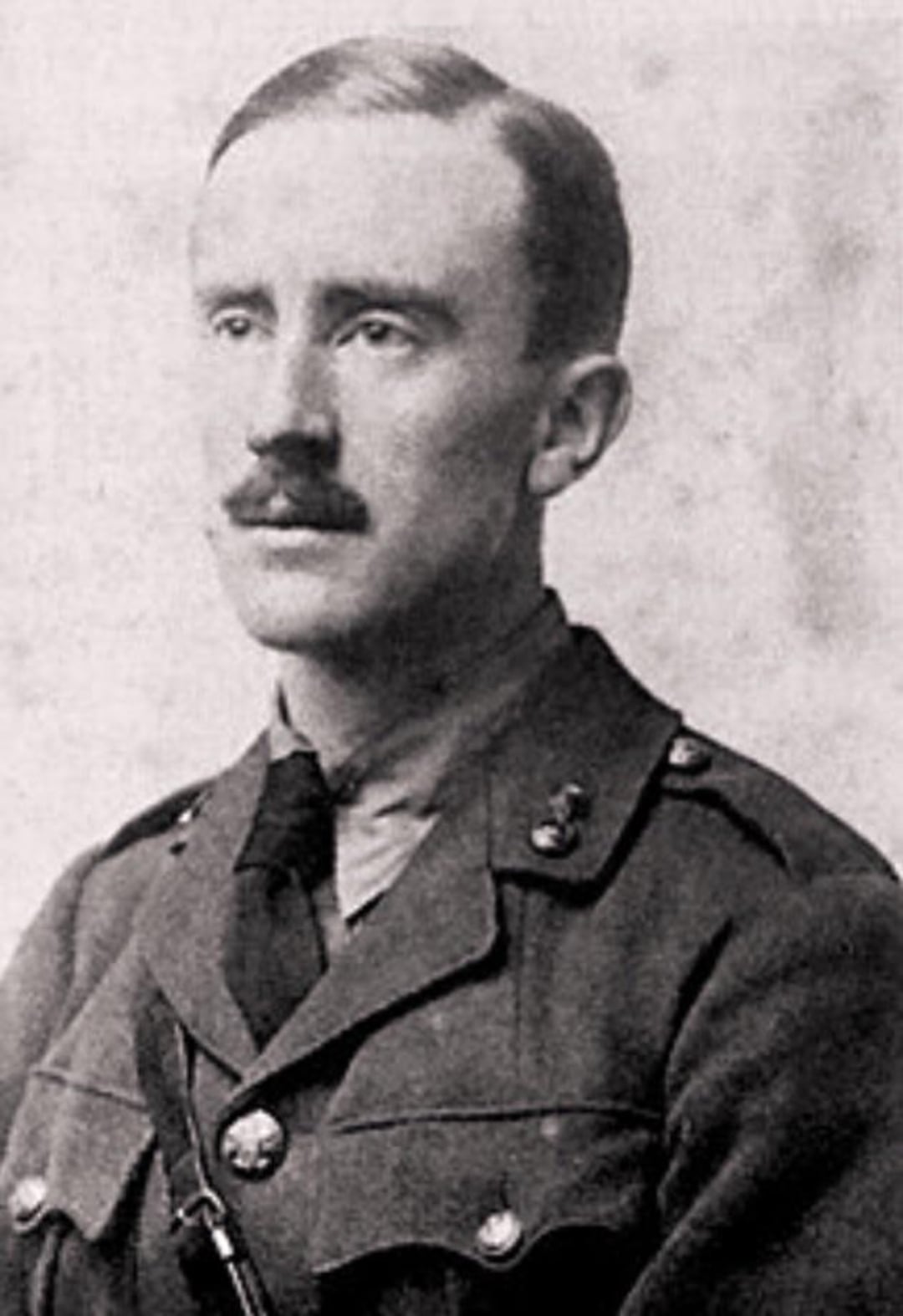 A black-and-white photograph of a man in a military uniform with short hair and a mustache, facing slightly to the left. The background is plain and neutral.