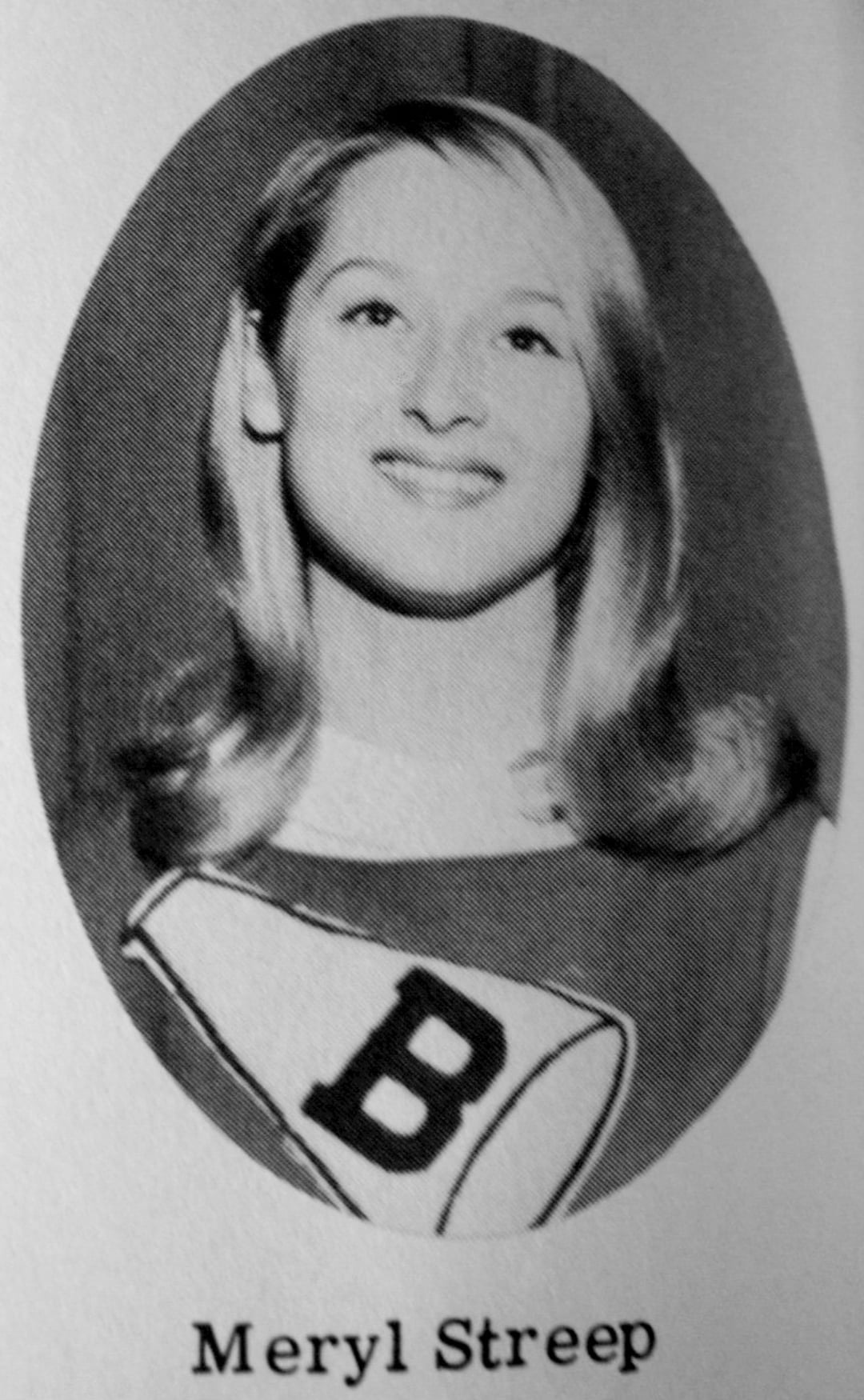 A black-and-white yearbook photo of a young woman with light hair, smiling. She is wearing a top with a large letter "B" on it. The name "Meryl Streep" is printed below the portrait.