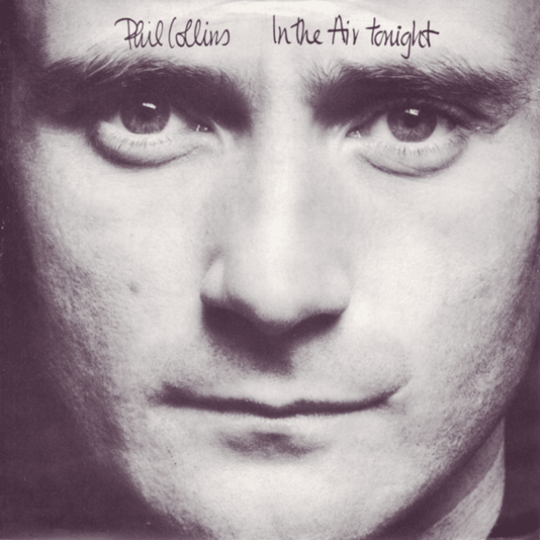 Close-up black-and-white image of a man's face, centered and serious. At the top, handwritten text reads "Phil Collins In the Air tonight.