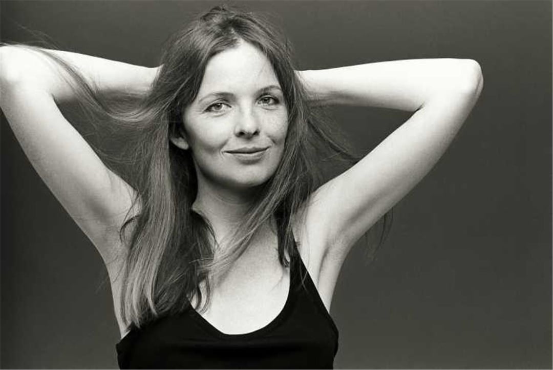 A woman with her hands behind her head