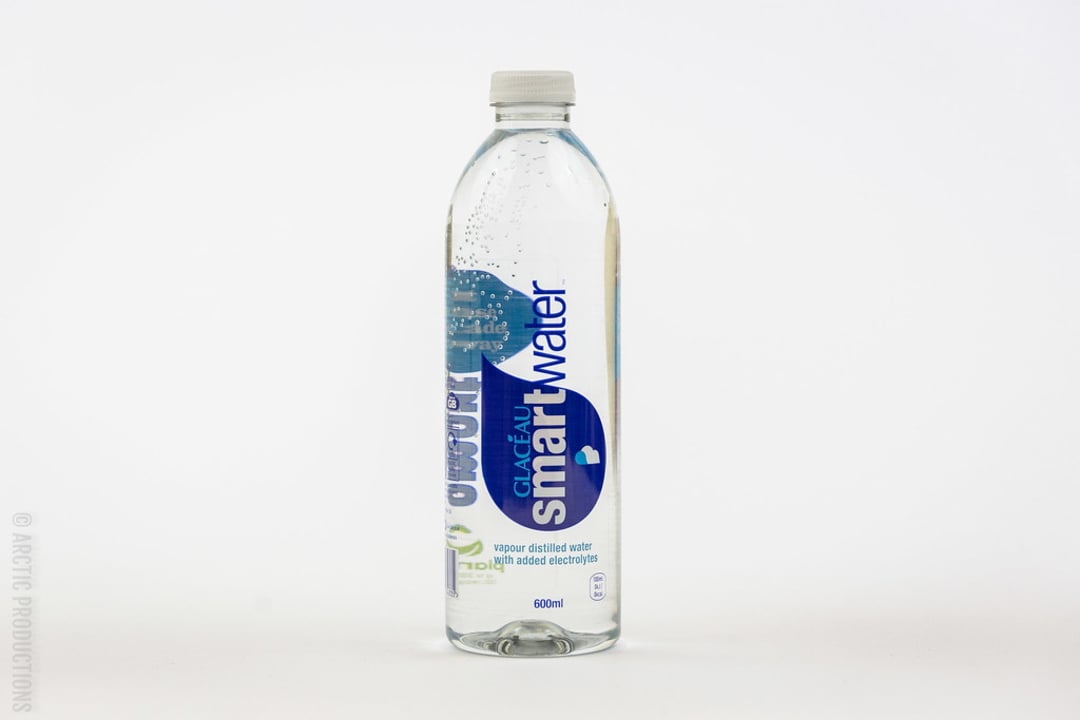 A 600ml clear plastic bottle of Glacéau Smartwater, containing vapor-distilled water with added electrolytes, standing upright against a plain white background.