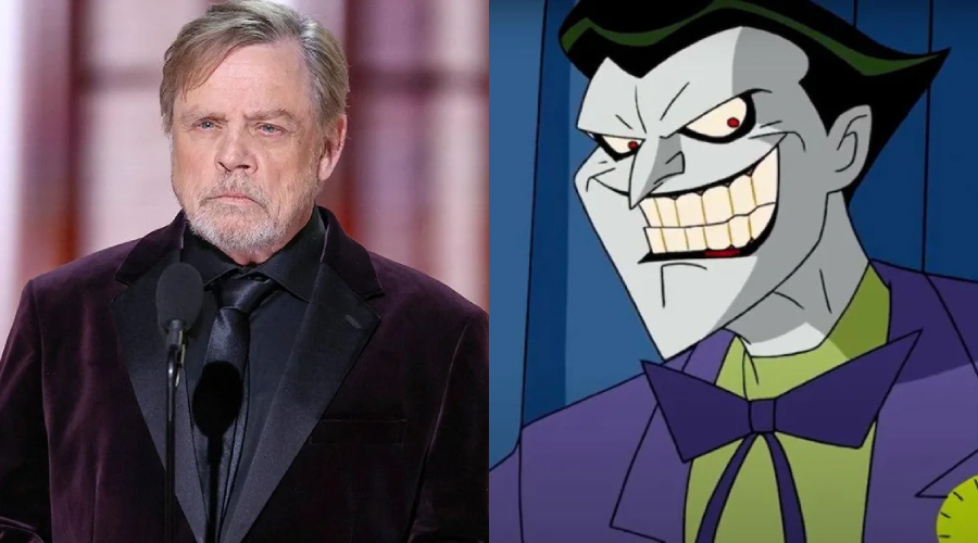 A man in a dark suit stands at a microphone on the left, and an animated character with white skin, green hair, and a wide grin wearing a purple suit is on the right.