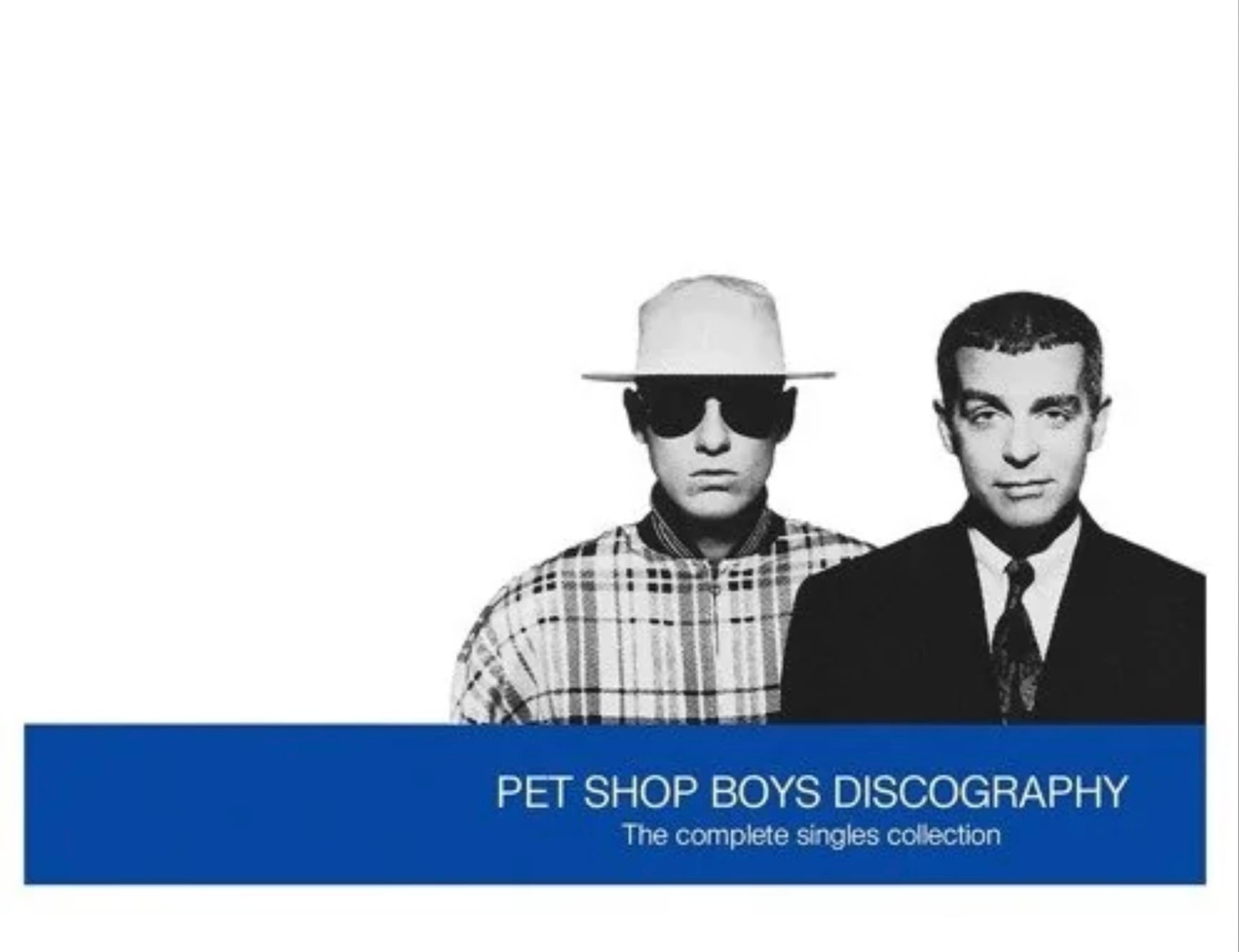Two men stand side by side against a white background; one wears sunglasses, a white hat, and a plaid shirt, while the other wears a suit. Text below reads, “PET SHOP BOYS DISCOGRAPHY The complete singles collection.”