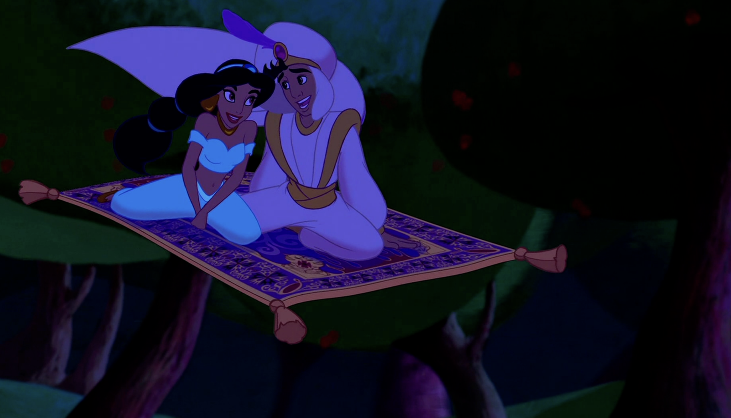 Aladdin and Jasmine sit close together on a flying magic carpet, soaring high above trees at night, both smiling happily.