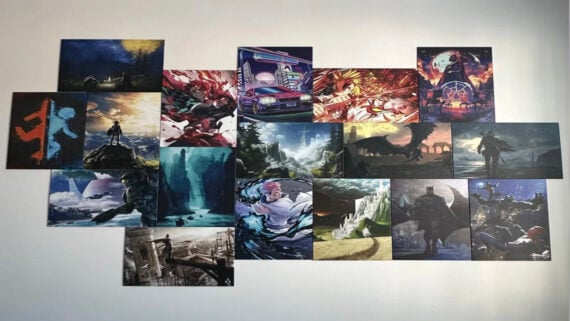 A grid of colorful fantasy and sci-fi art prints, featuring dramatic landscapes, characters, creatures, and scenes from various video games and anime, displayed on a white wall.