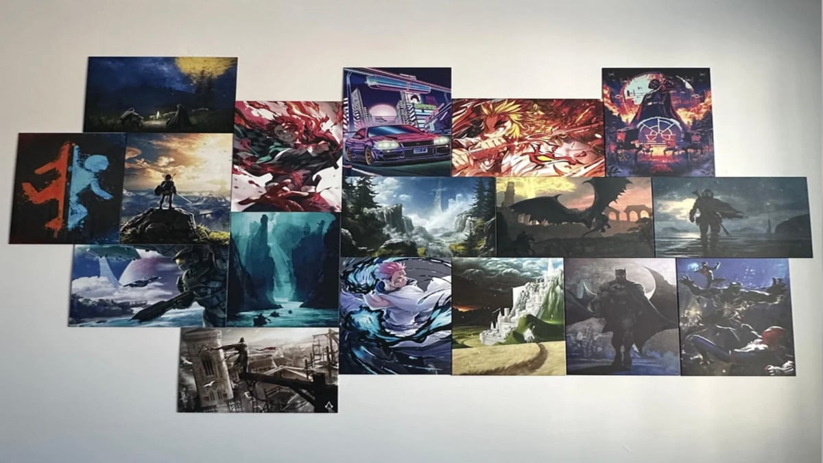 A grid of colorful fantasy and sci-fi art prints, featuring dramatic landscapes, characters, creatures, and scenes from various video games and anime, displayed on a white wall.