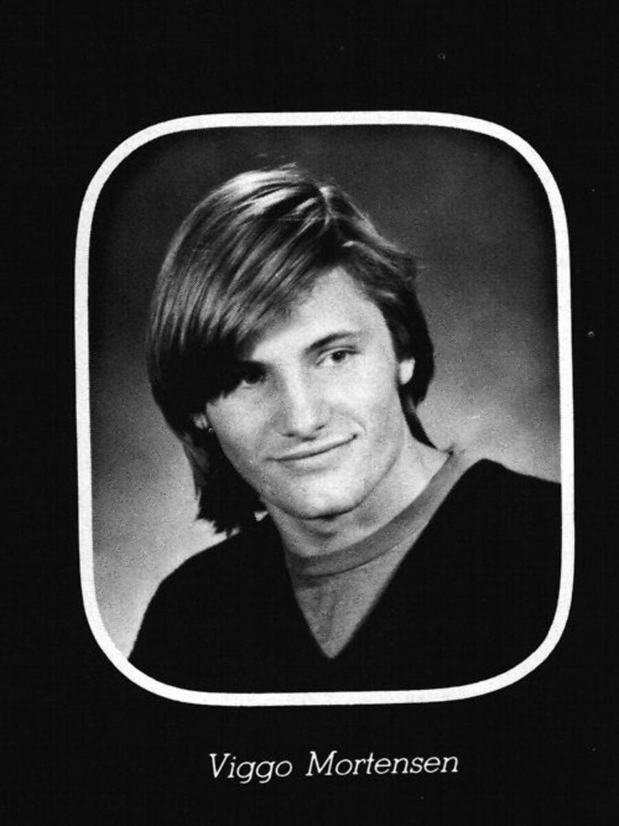 A black and white yearbook photo of a young man with medium-length hair, wearing a sweater over a shirt, framed by a white oval border, with the name "Viggo Mortensen" written below the image.