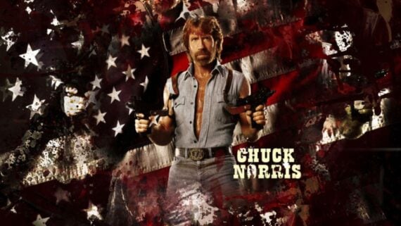 A man with a beard in a sleeveless denim shirt holds two pistols against a background featuring a faded American flag and stars. The name "Chuck Norris" appears in bold yellow text.
