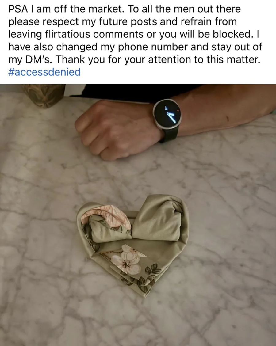 A person's arm with a tattoo and a watch rests on a marble surface. In front, clothing is folded into a heart shape. Text above announces the person is off the market and requests respect in DMs.
