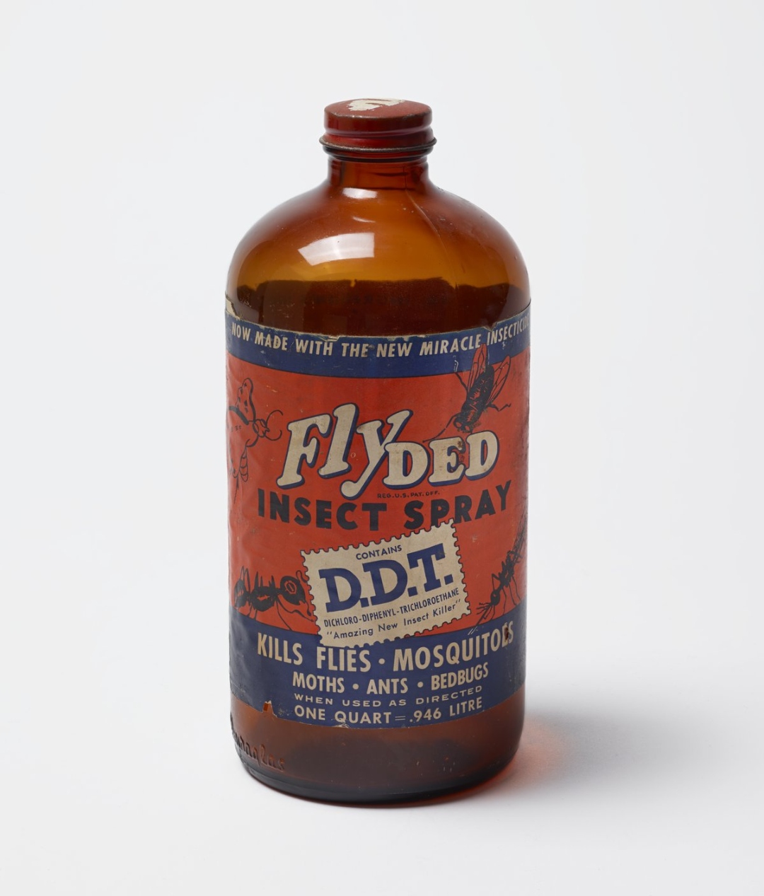 A vintage brown glass bottle labeled "Flyded Insect Spray" with bold red, blue, and yellow text. The label advertises that it contains DDT and kills flies, mosquitoes, moths, ants, and bedbugs.