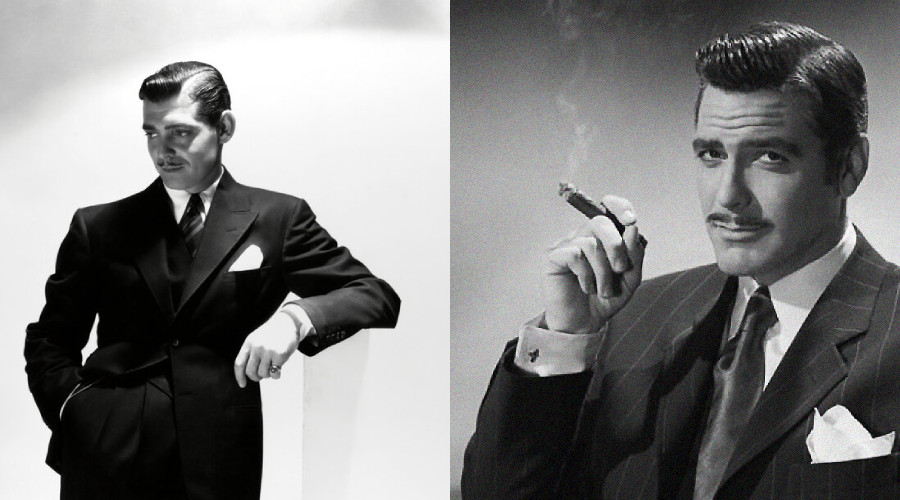 Two men in vintage black-and-white portraits wear classic suits; the man on the left stands with a hand in his pocket, while the man on the right sits, holding a cigar and gazing confidently at the camera.