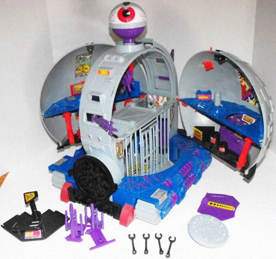 A toy playset resembling a sci-fi lab with a large eyeball on top, open dome-shaped sides, a central cage, control panels, various purple accessories, tools, and stickers with warning symbols.