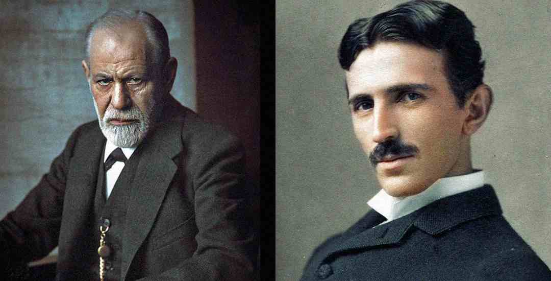 Two men in formal, old-fashioned suits; the man on the left has gray hair and a beard, looking serious, while the man on the right has dark hair and a mustache, looking calmly at the camera.