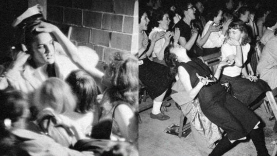 Elvis Presley surrounded by excited fans reaching out to him