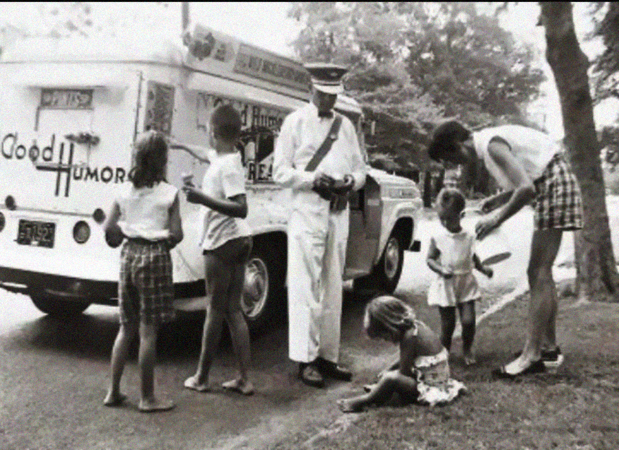 A vintage black-and-white photo shows children and a woman buying ice cream from a Good Humor truck, served by a uniformed vendor. One child sits on the curb while others wait with anticipation. Trees line the street.