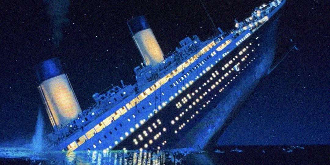 A large ship with two smokestacks tilts steeply into the ocean at night, its lights glowing as water floods the lower decks, depicting a dramatic maritime disaster.