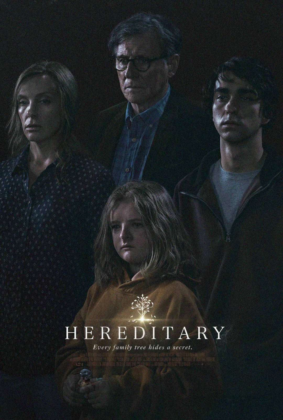 A somber family of four stands together in a dimly lit setting. The word "Hereditary" appears at the bottom with the tagline "Every family tree hides a secret" and a tree illustration above the title.