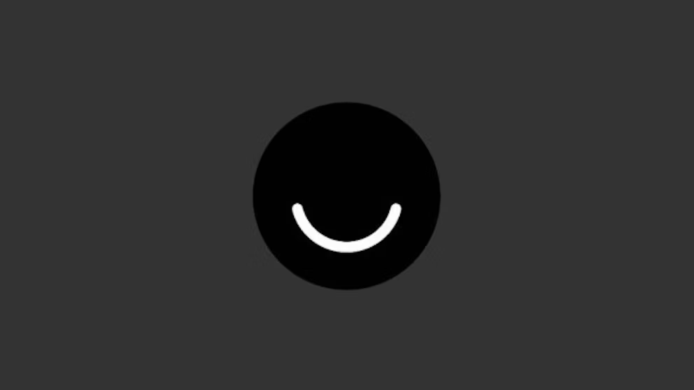 A black circle with a white curved line resembling a smile is centered on a dark gray background.