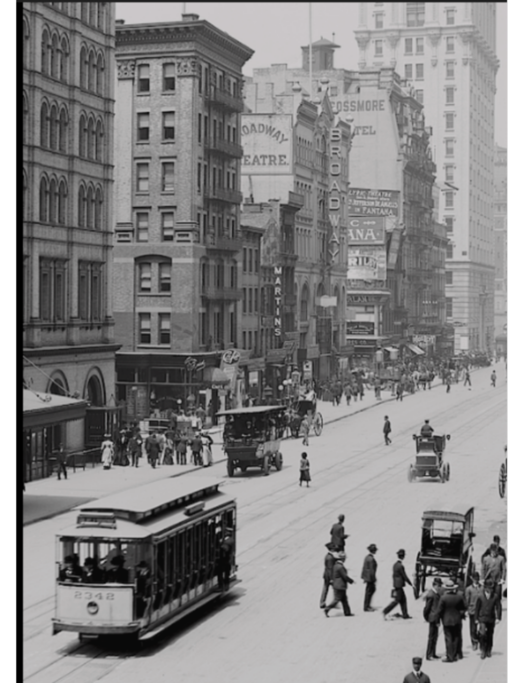 Black-and-white photo of a busy city street in the early 1900s, with people walking, streetcars, horse-drawn carriages, and tall buildings lined with signs and advertisements.
