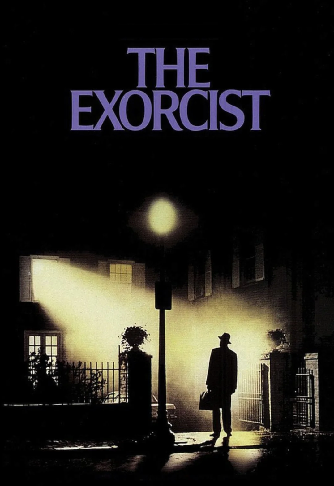 A shadowy figure stands under a streetlamp outside a house with bright light streaming from a window at night. Above, large purple text reads, "THE EXORCIST" against a dark background.
