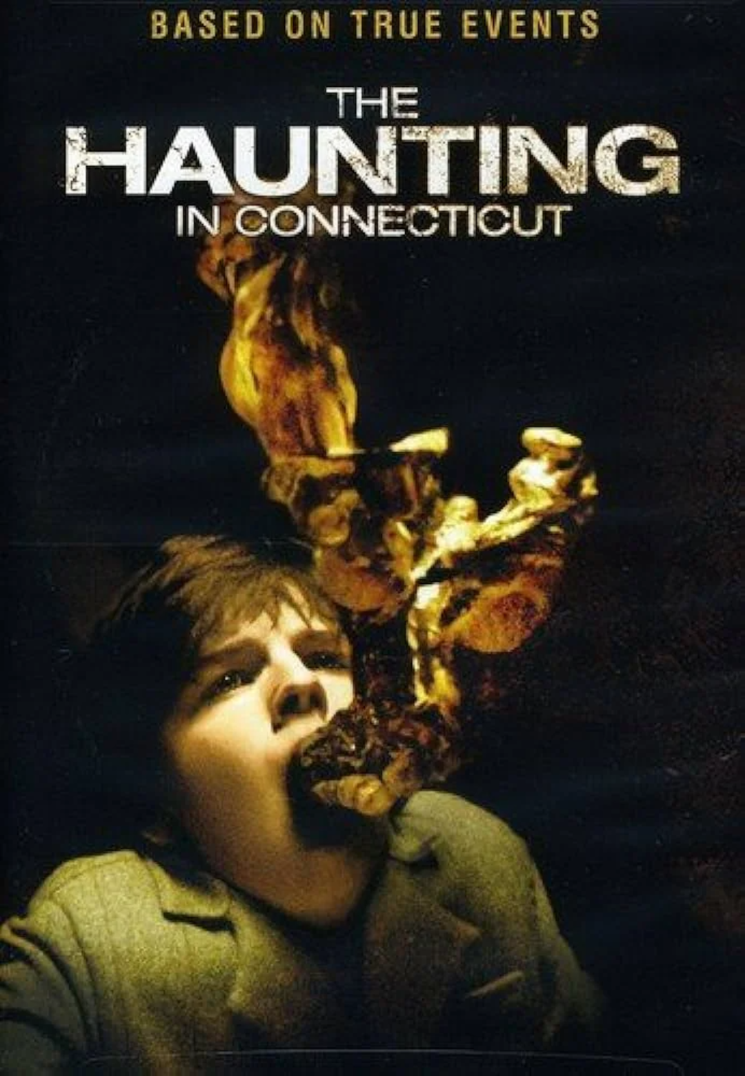 Movie poster for "The Haunting in Connecticut" shows a frightened boy with his head tilted back as a smoky, skeletal hand-like shape emerges from his mouth. The background is dark and the movie title is above him.