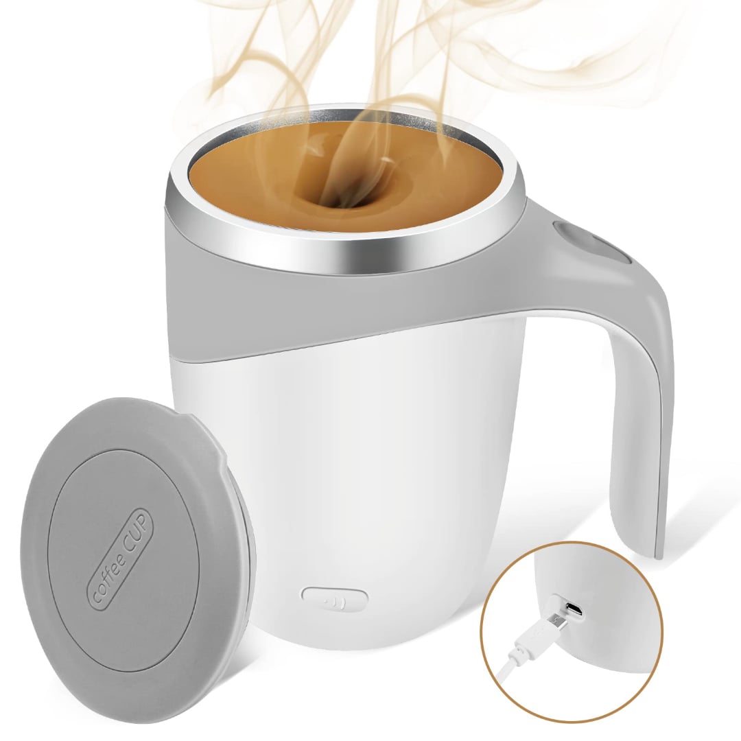 A white and gray electric coffee mug with steam rising from hot coffee inside; lid placed beside the mug and a charging cable shown plugged into the mug’s base.