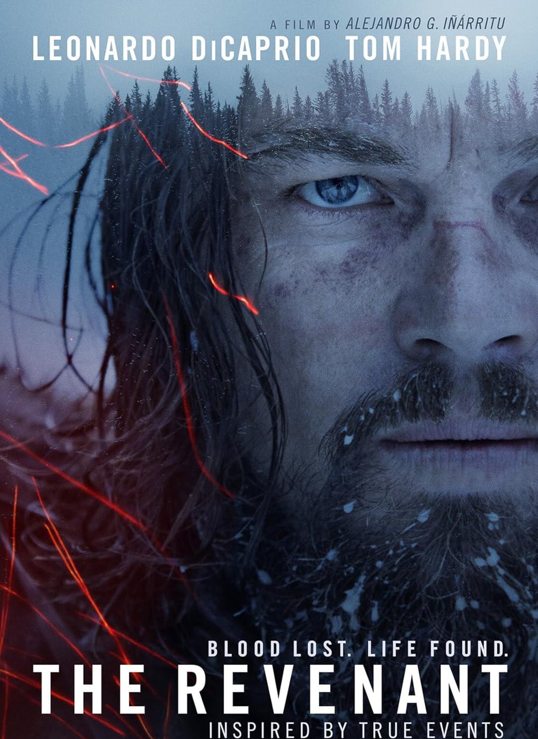 Close-up of a rugged, bearded man with intense blue eyes and a frosty face, overlaid with red crack-like lines and silhouettes of trees. Text reads: “The Revenant. Blood Lost. Life Found. Inspired by True Events.”