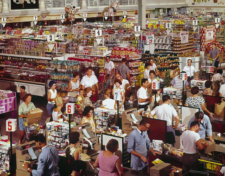 A busy supermarket scene from the past, with crowded checkout lanes, shoppers in vintage clothing, and cashiers at numbered registers. Shelves are stacked high with colorful groceries and products.