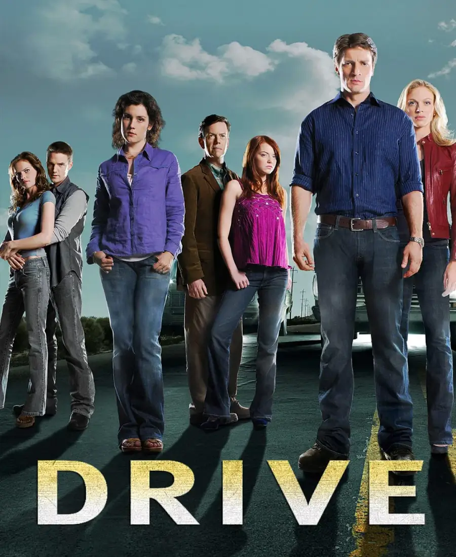 Seven people stand together on a road with a cloudy sky behind them. The word “DRIVE” is written in large letters at the bottom. The group looks serious, with a car partially visible in the background.